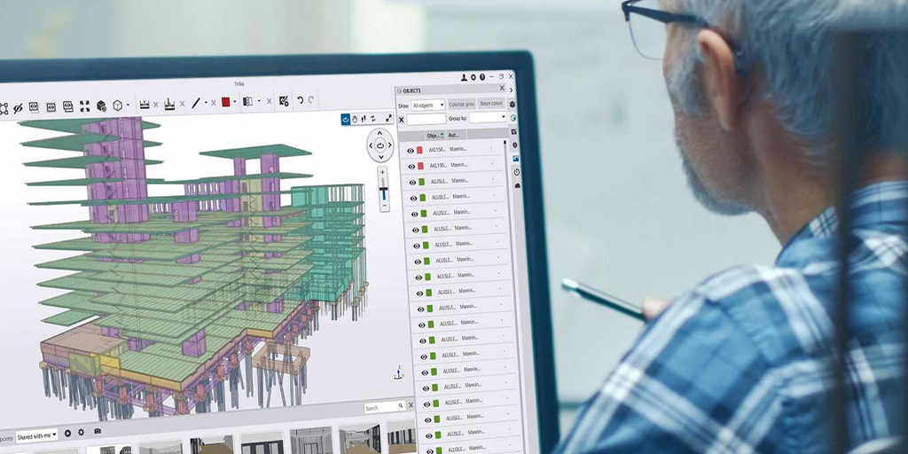 engineer looking at computer monitor of a building structure